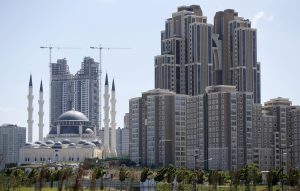 Residential towers are seen next to the newly built Mimar Sinan mosque in Atasehir on the Asian side of Istanbul in this September 4, 2012 file photo. Perched on the edge of a wasteland earmarked to become a financial district on Istanbul's Asian side, the curved facades of five massive luxury tower blocks sparkle in the sunshine, the centrepiece of a sprawling new residential complex. It is the sort of development that overseas property buyers in Turkey, mainly from Europe, have usually shied away from, investing instead in holiday homes along the country's Mediterranean and Aegean coasts. But a new wave of wealthy investors from the Middle East and Russia is increasingly eyeing luxury developments in bustling Istanbul, lured by a relaxation in property laws, relatively cheap prices and a thriving economy. Picture taken September 4, 2012. To match TURKEY-PROPERTY/(MIDEAST MONEY)  REUTERS/Murad Sezer (TURKEY - Tags: BUSINESS REAL ESTATE SOCIETY WEALTH) - RTR385H2