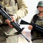 Turkish soldiers stand guard at a check point on the main road between Mardin and Cizre near the southeastern town of Midyat, Turkey